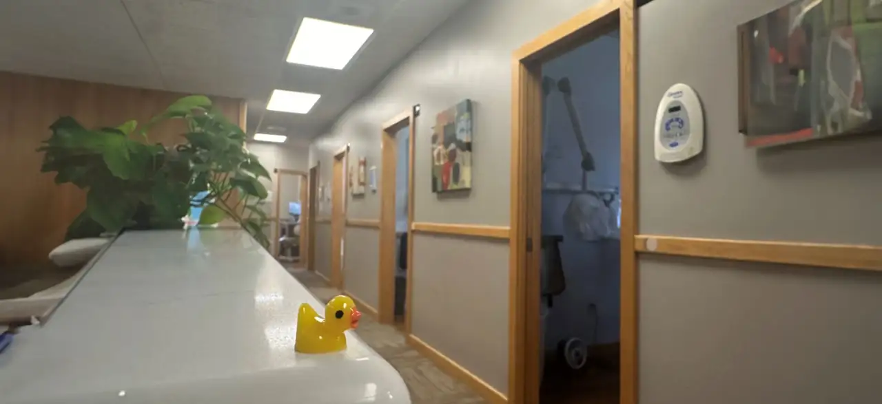 The hallway to the treatment rooms at 1330 Dental Associates, with a rubber duck on the front counter.